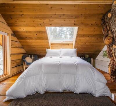 The 850 down comforter from Feathered Friends in a beautiful cabin setting.