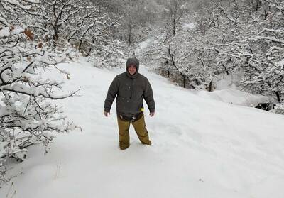 Man in Orvis Pro Insulated Hoodie in snow postholing