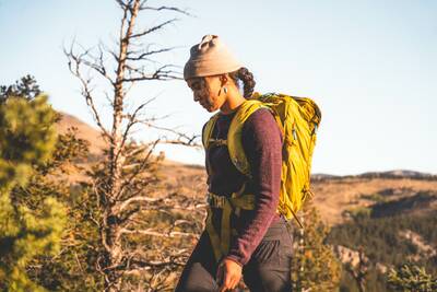 Woman hiking in mountain crew sweater